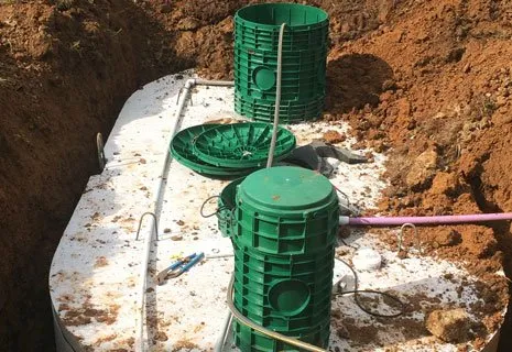 Green risers and lids installed on a buried septic tank